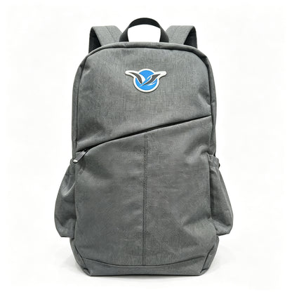 A gray fabric backpack with a diagonal front pocket, side pockets, and a blue and white bird logo patch on the front, shown against a plain white background.
