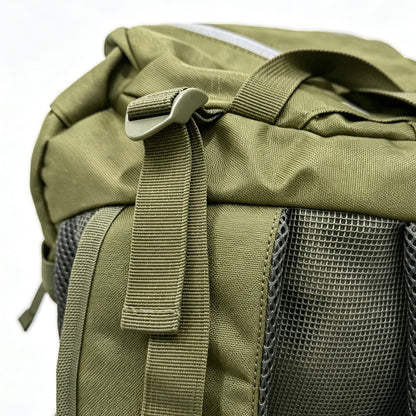 Close-up of an olive green tactical backpack showing the top flap, plastic buckle, webbing strap, and dark gray mesh ventilation pockets.