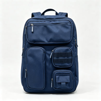 A navy blue multi-compartment backpack with multiple zippered pockets and a top handle, photographed against a clean white studio background.
